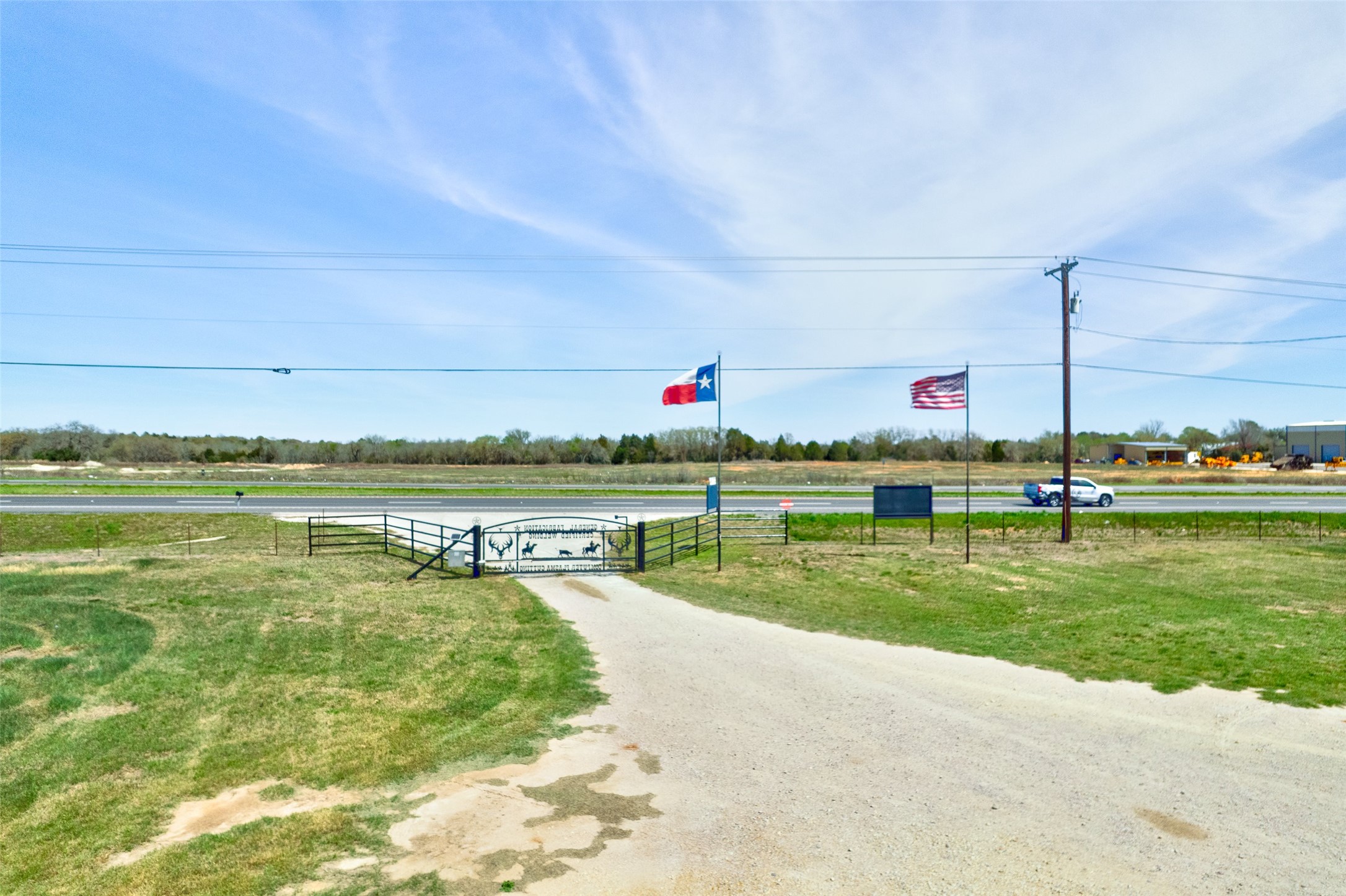 290 Highway 290 East Elgin, TX 78621 - Photo 20 of 24 View of road featuring a gated entry and a gate