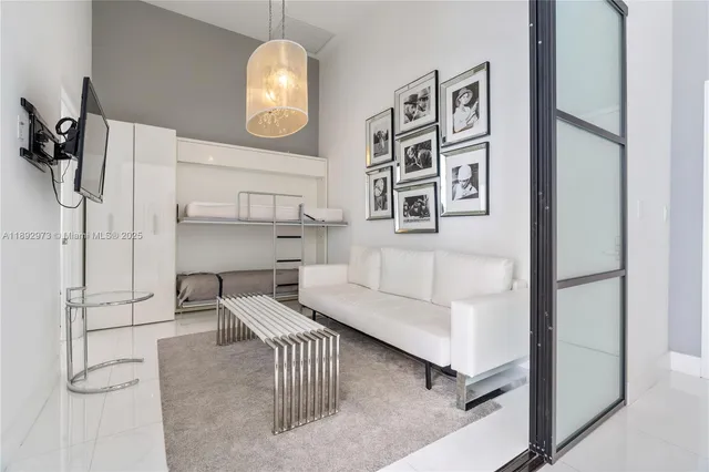 a living room with furniture and a chandelier