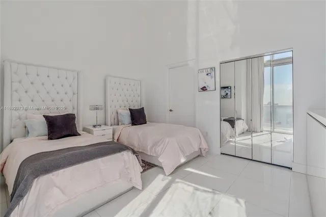 a bedroom with two beds and painted walls