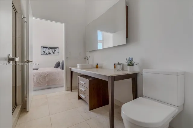 a bathroom with a sink toilet and mirror