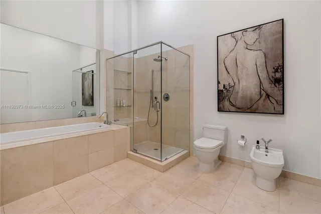 a bathroom with a toilet sink and shower