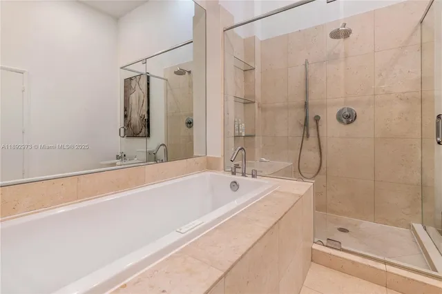a bathroom with a bathtub and a shower