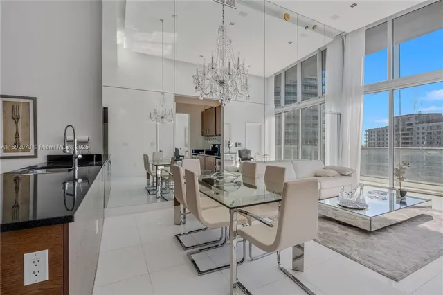 a living room with fireplace furniture and a chandelier