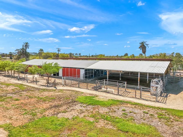 a view of a swimming pool with a patio and a yard