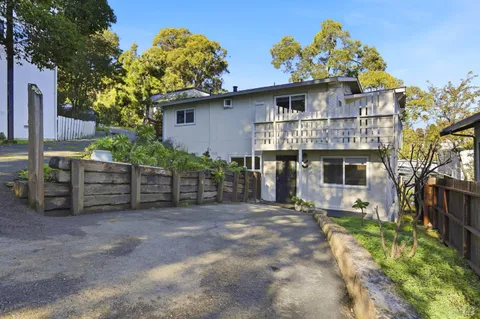 a front view of house with yard outdoor seating and barbeque oven