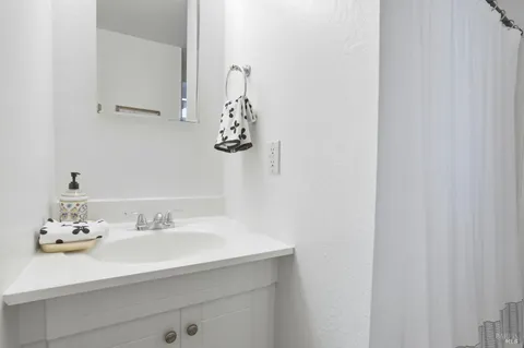 a bathroom with a granite countertop toilet and a shower
