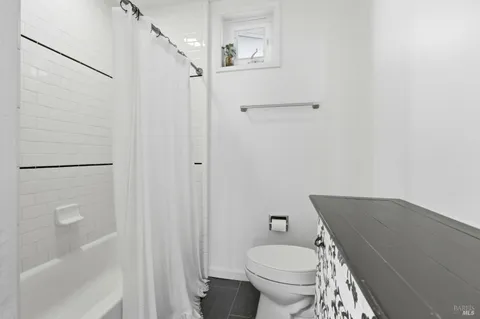 a view of a patio with a table and chairs