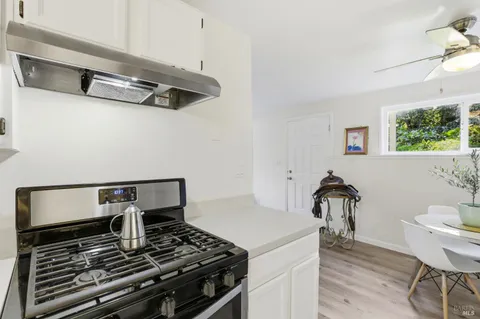 a view of a workspace with furniture and wooden floor
