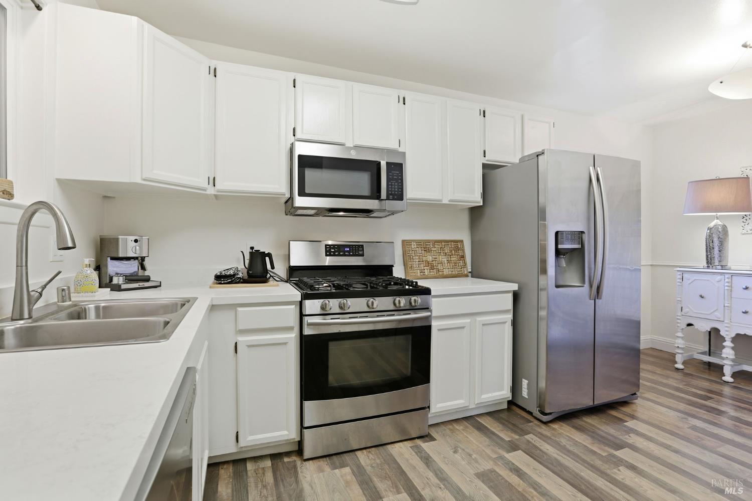 280 Prospect Drive San Rafael, CA 94901 - Photo 9 of 38 a kitchen with stainless steel appliances white cabinets a sink a stove a refrigerator and microwave
