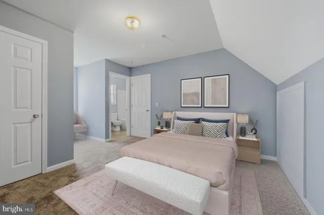 a bedroom with a large bed and a rug