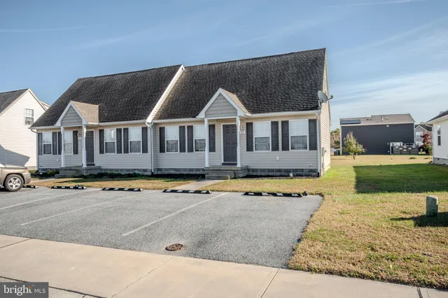 a front view of a house with swimming pool and yard