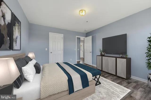 a bedroom with a bed and a flat screen tv