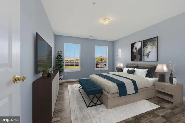 a bedroom with bed and a flat screen tv