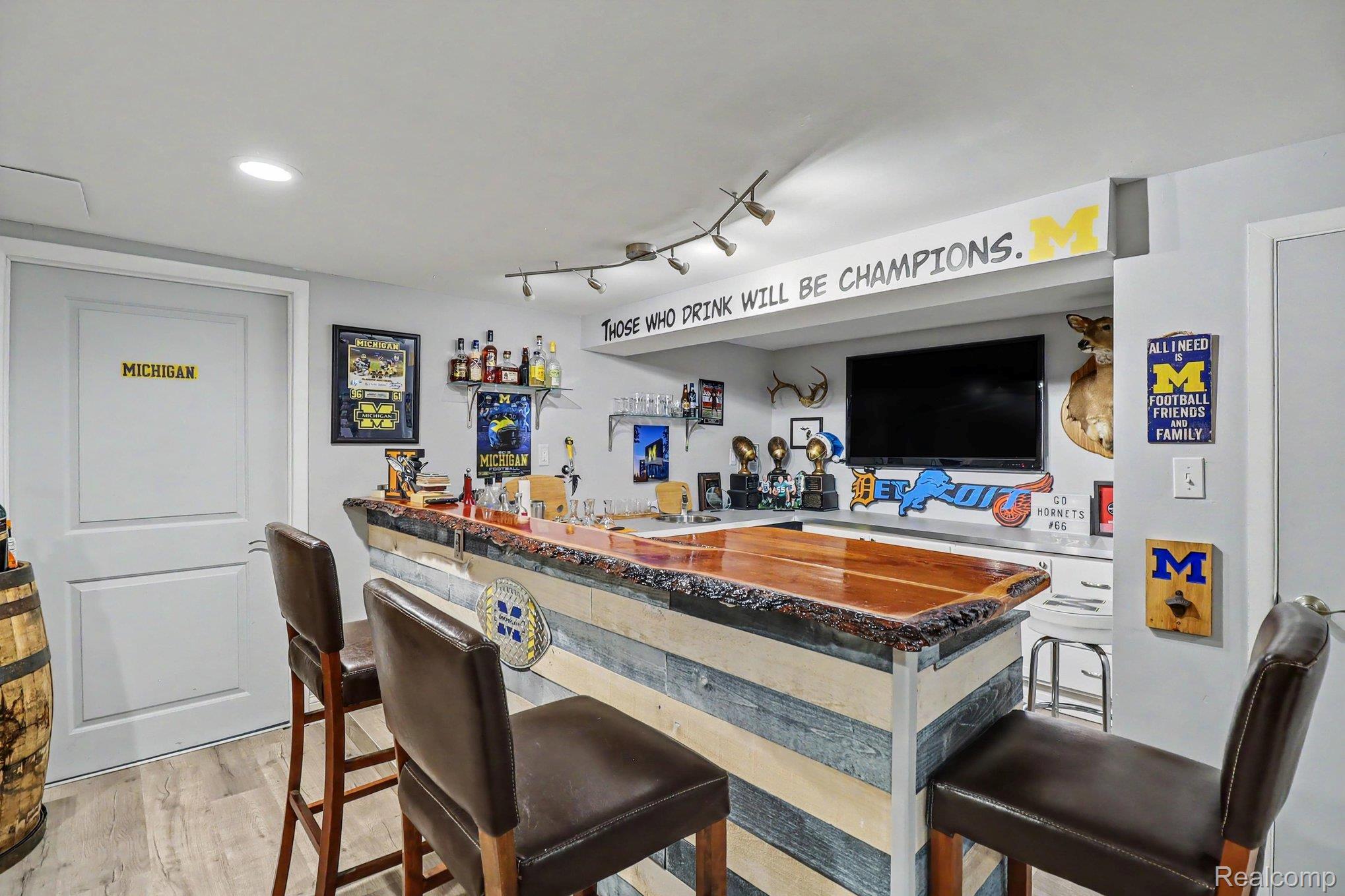 24404 Jamestowne Road Novi, MI 48375 - Photo 20 of 26 Built-in bar with a live-edge wood top, wood-finish flooring, and recessed lighting