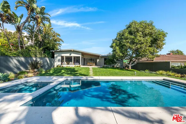 a view of house with swimming pool outdoor seating