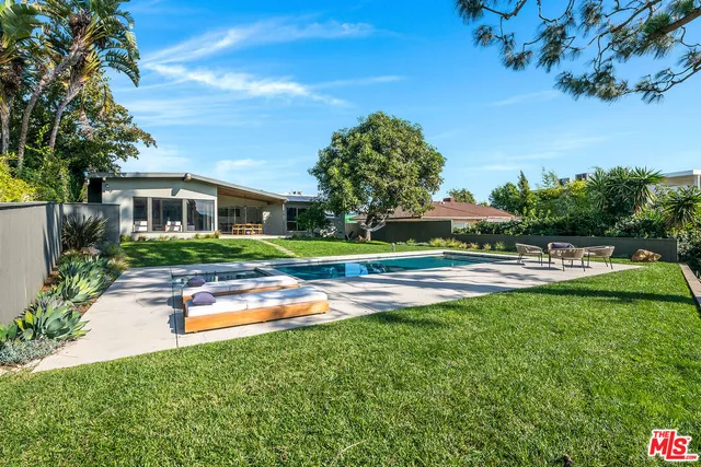 a swimming pool with outdoor seating and yard
