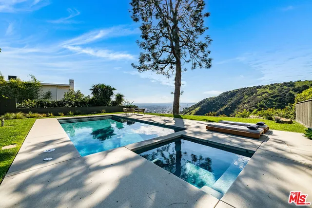 a view of swimming pool with a lounge chairs