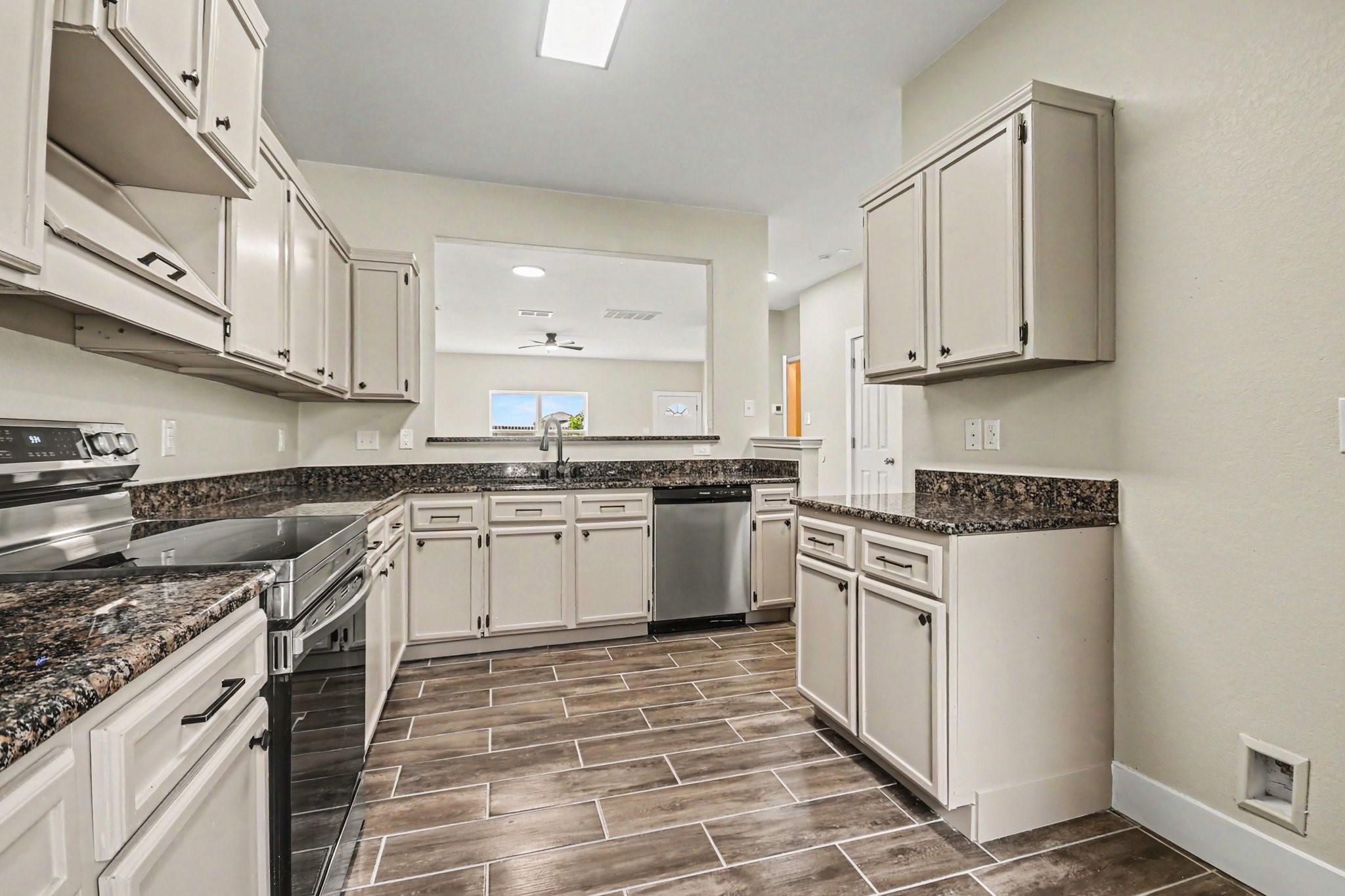 1322 Diamond Drape Drive Rosharon, TX 77583 - Photo 10 of 45 a kitchen with stainless steel appliances granite countertop a stove a sink and a refrigerator