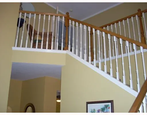 a view of staircase with railing and a rug