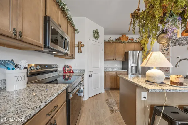 a kitchen that has a lot of cabinets and appliances