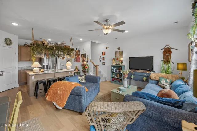 a living room with furniture and a wooden floor