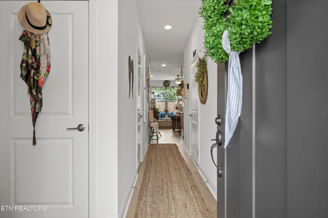 a view of a hallway with wooden floor and entryway