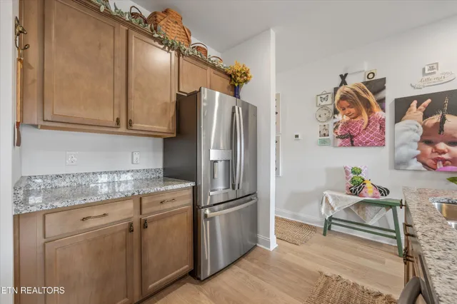 a kitchen with stainless steel appliances granite countertop a refrigerator and a sink