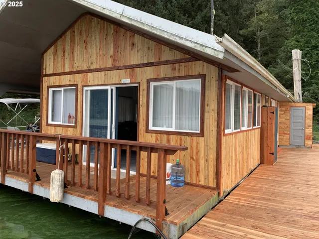 a view of a house with backyard and deck
