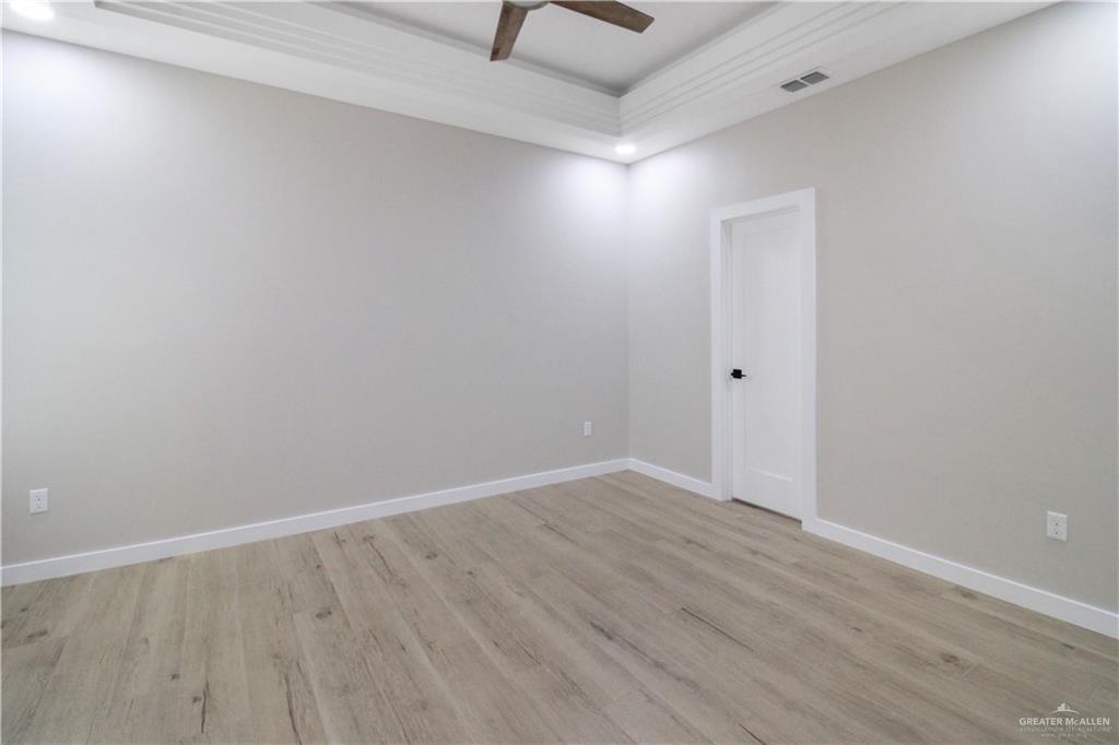 2202 Corales Street Mission, TX 78573 - Photo 8 of 18 Empty room featuring light wood-style flooring and a ceiling fan
