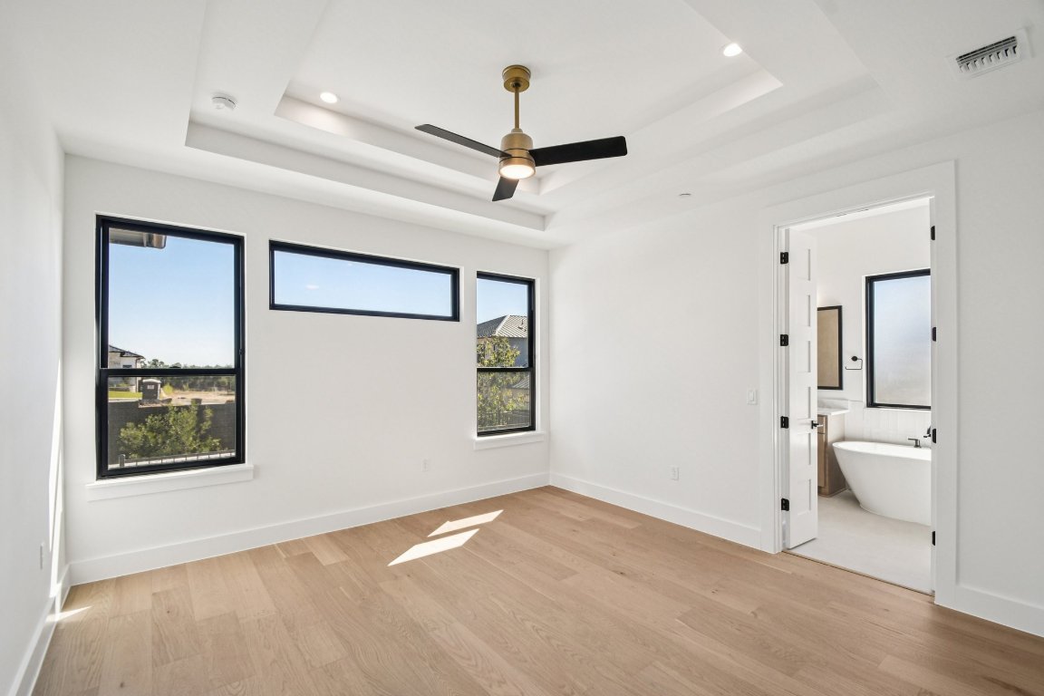 5903 Moondust Lane Austin, TX 78730 - Photo 16 of 37 a view of an empty room with a window and wooden floor