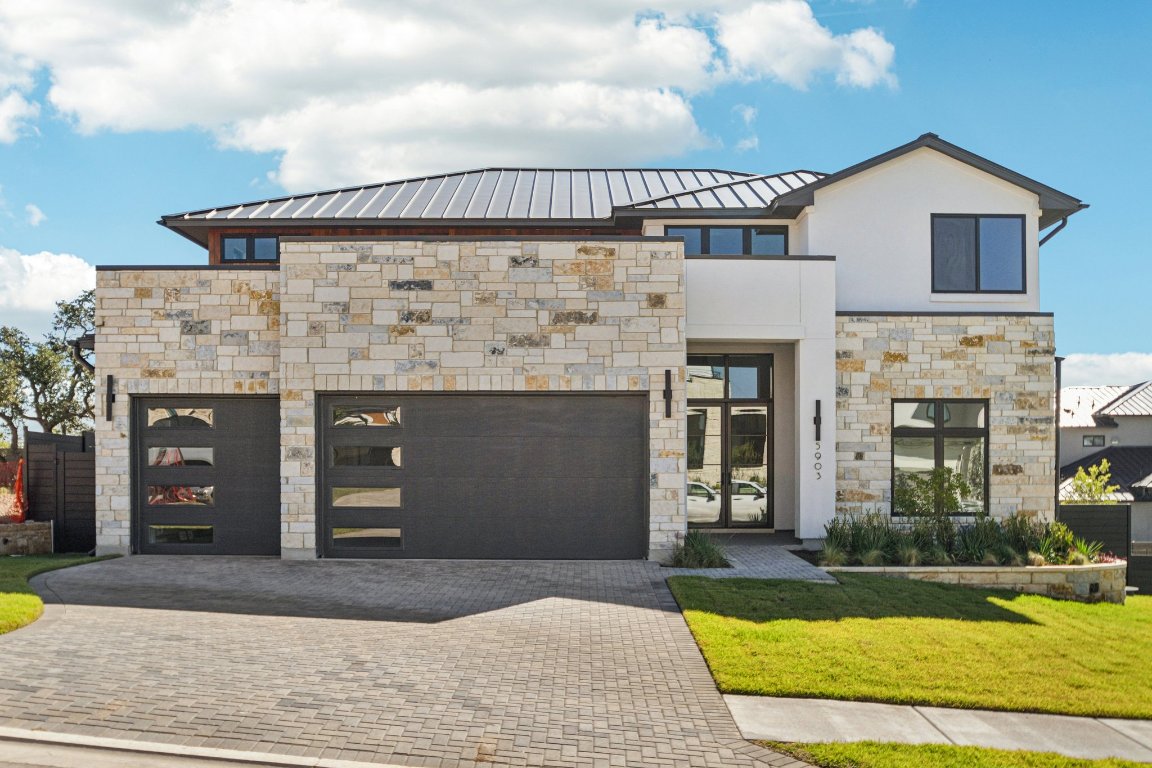 5903 Moondust Lane Austin, TX 78730 - Photo 2 of 37 a front view of a house with a yard and garage