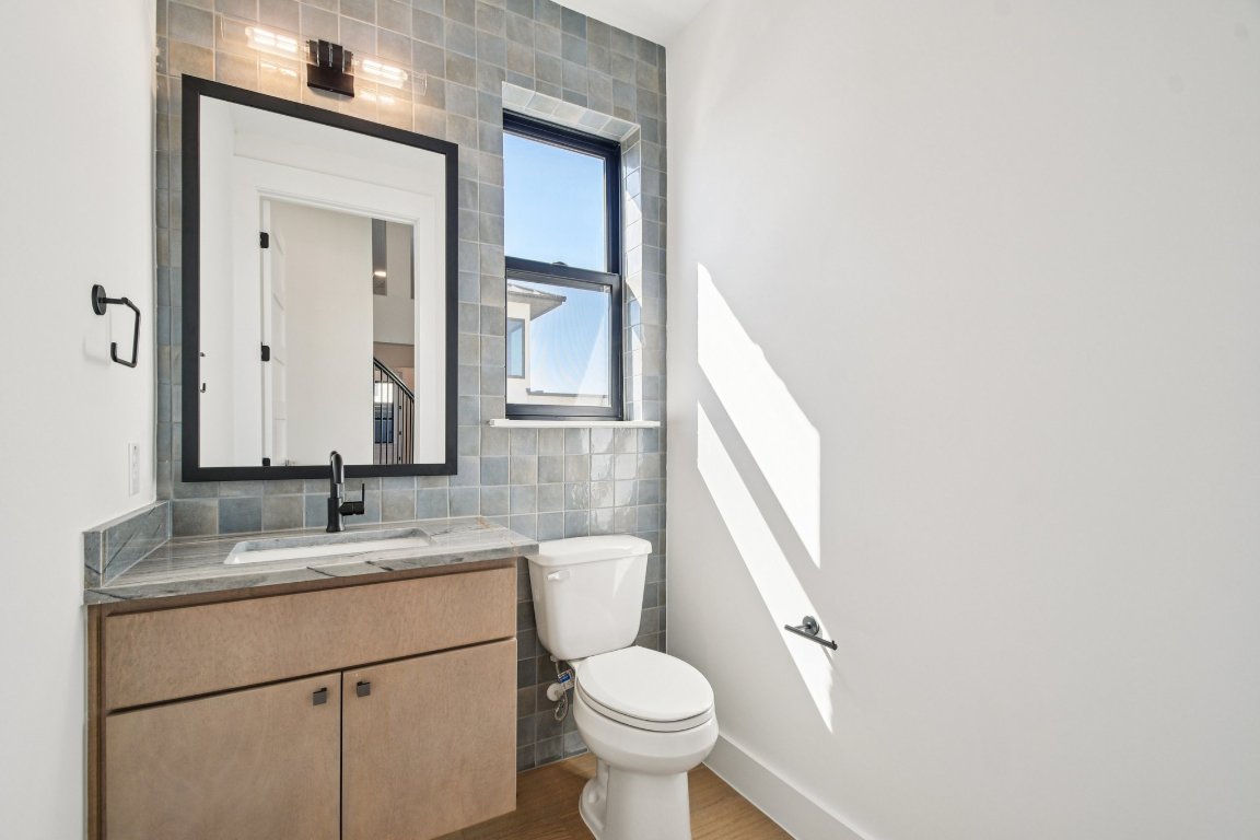 5903 Moondust Lane Austin, TX 78730 - Photo 21 of 37 a bathroom with a granite countertop toilet sink and mirror
