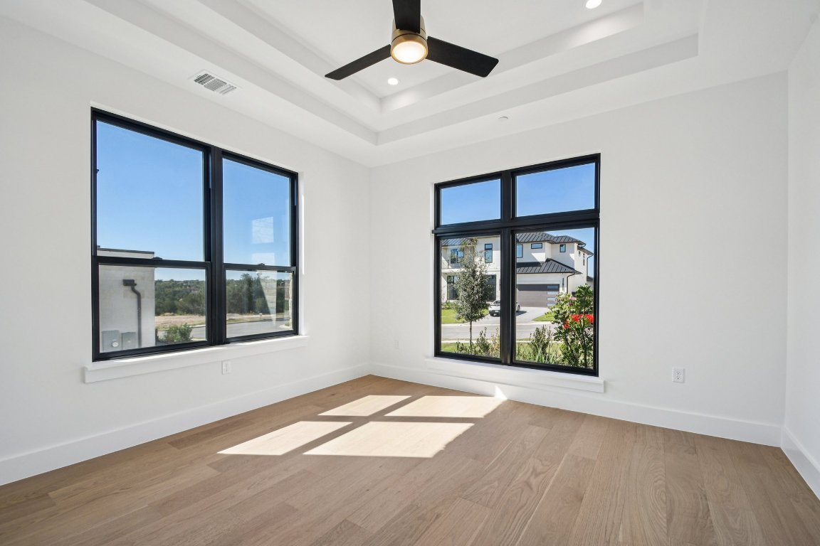 5903 Moondust Lane Austin, TX 78730 - Photo 22 of 37 an empty room with wooden floor and windows