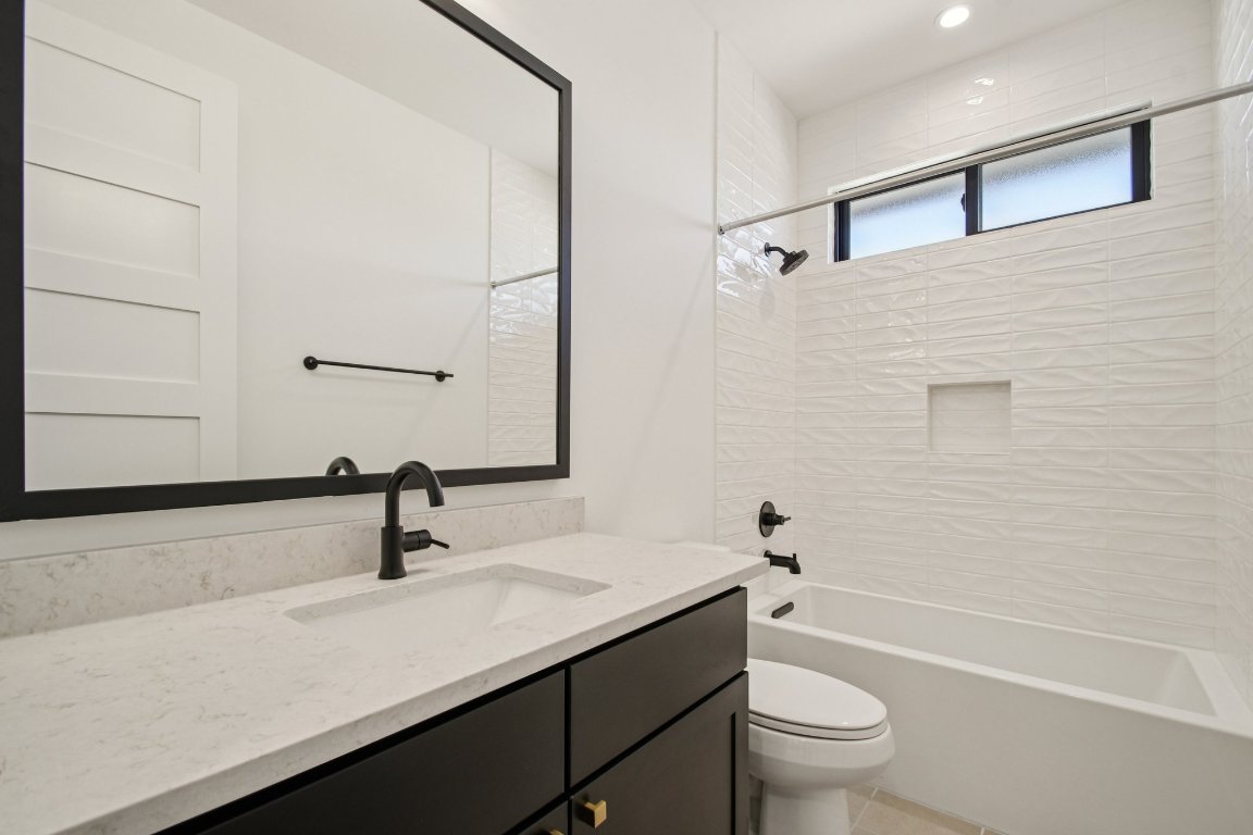 5903 Moondust Lane Austin, TX 78730 - Photo 26 of 37 a bathroom with a sink a toilet and a tub