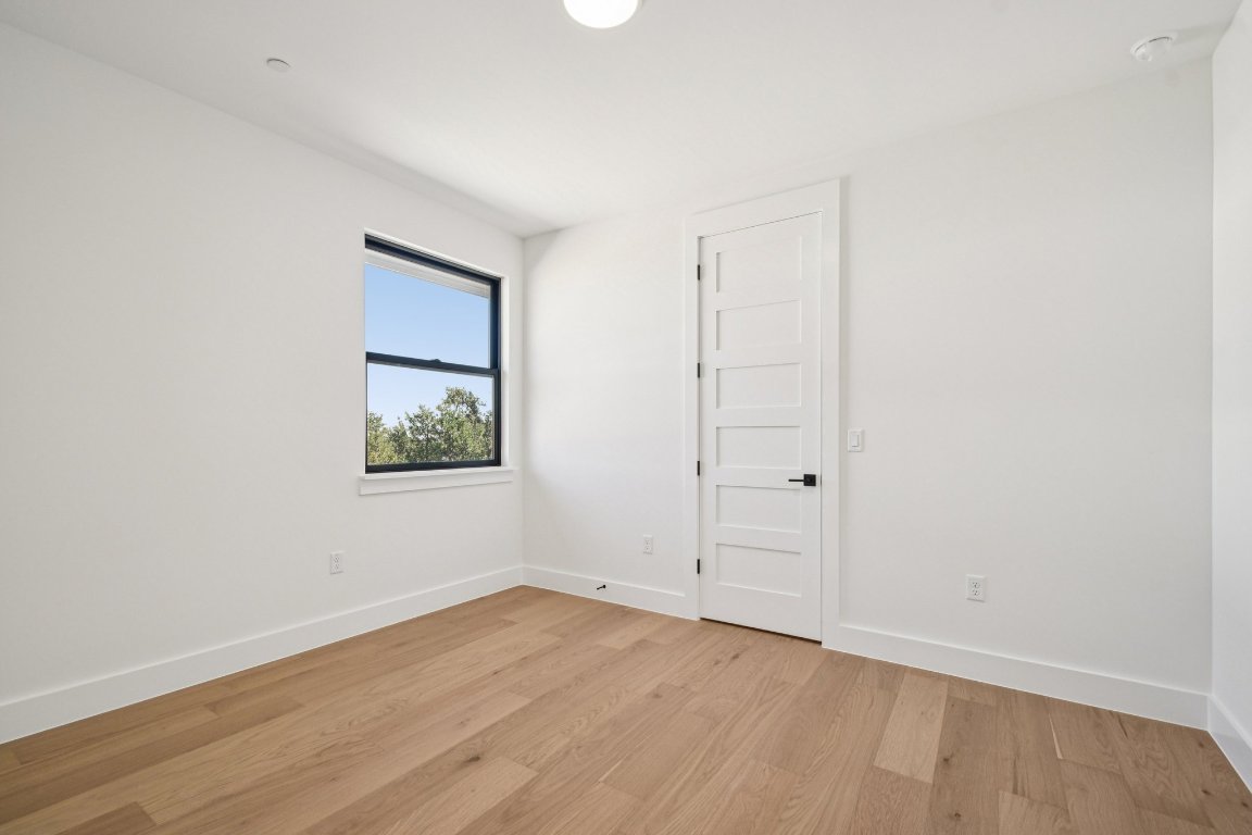 5903 Moondust Lane Austin, TX 78730 - Photo 27 of 37 an empty room with wooden floor and window