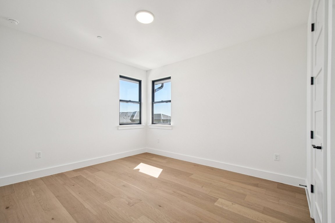 5903 Moondust Lane Austin, TX 78730 - Photo 30 of 37 an empty room with wooden floor and windows