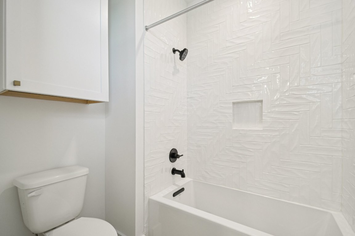 5903 Moondust Lane Austin, TX 78730 - Photo 32 of 37 a bathroom with a toilet and a bathtub