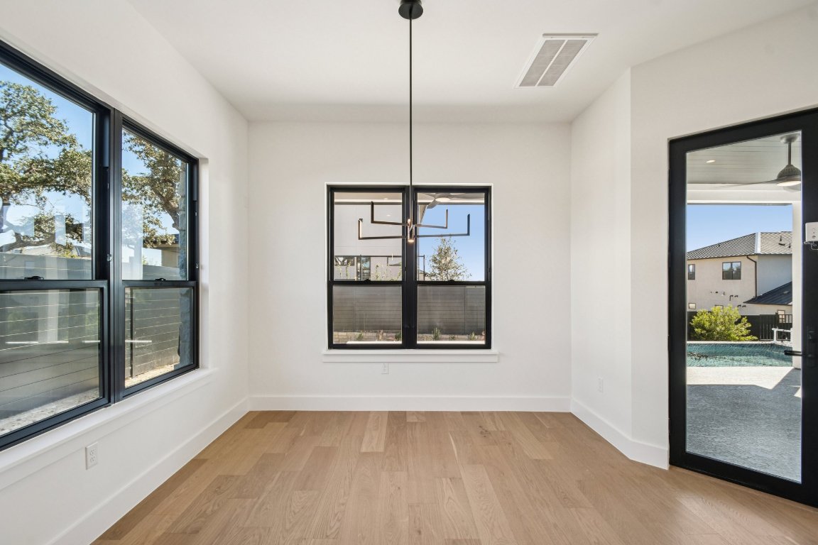 5903 Moondust Lane Austin, TX 78730 - Photo 9 of 37 a view of an empty room with a window and wooden floor