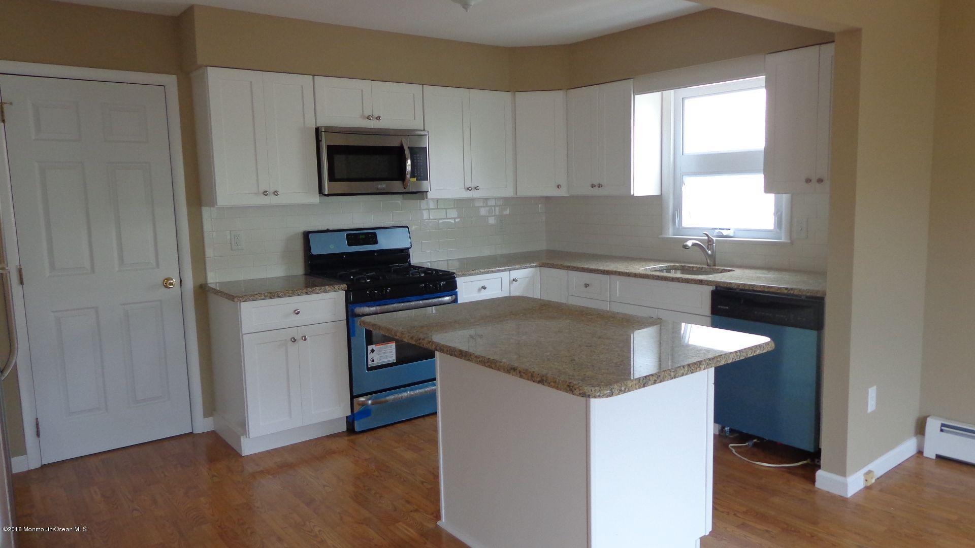 4 Garrett Road Toms River, NJ 08757 - Photo 5 of 19 a kitchen with granite countertop a sink and a stove top oven