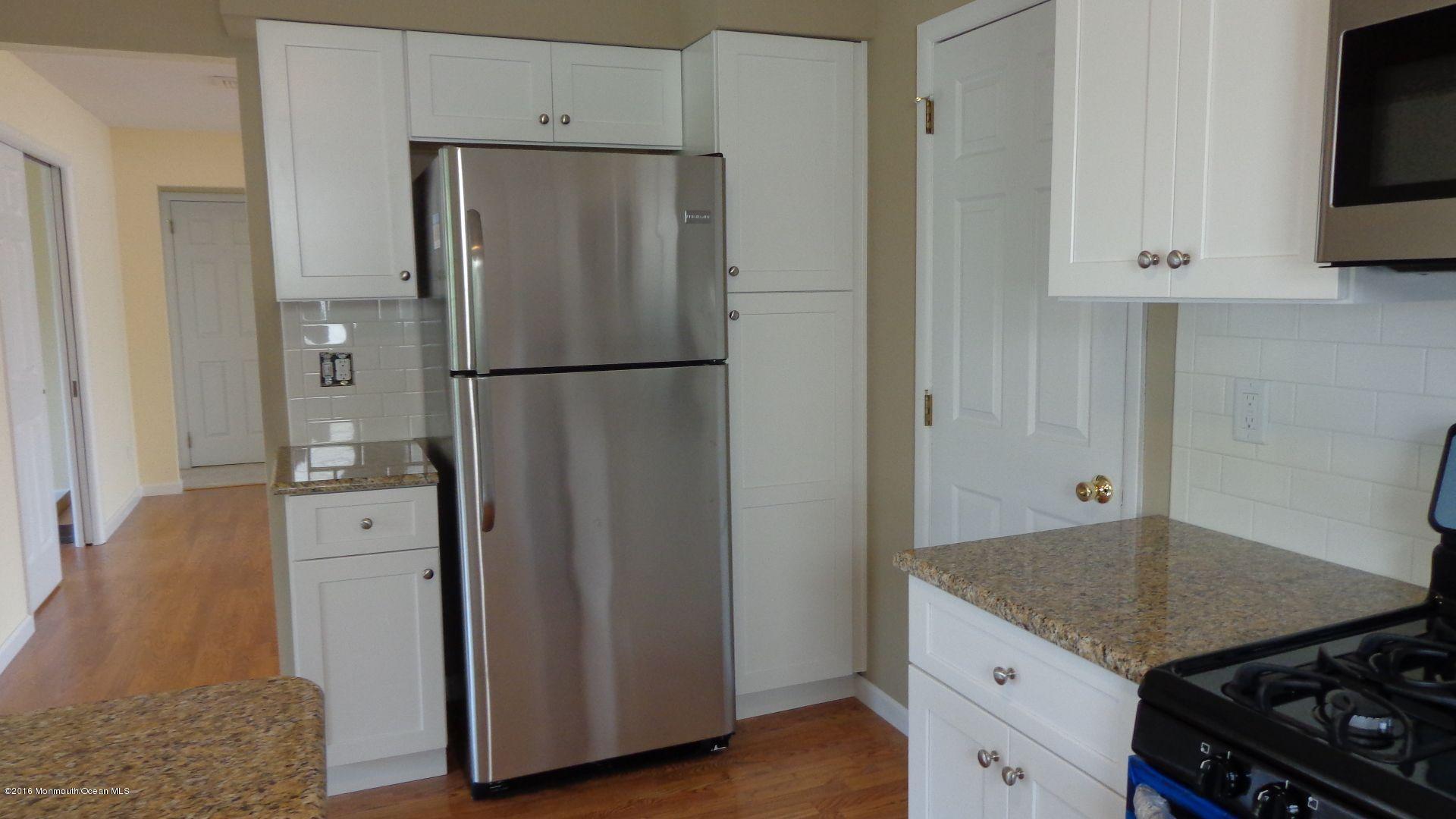 4 Garrett Road Toms River, NJ 08757 - Photo 7 of 19 a kitchen with stainless steel appliances a refrigerator a stove a microwave and cabinets