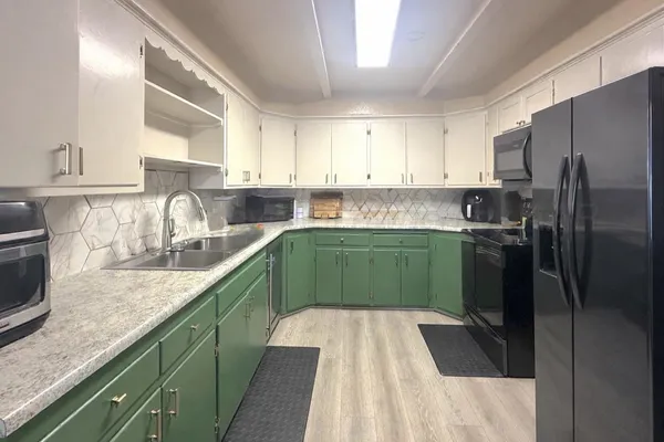 a kitchen with a refrigerator a sink and a stove