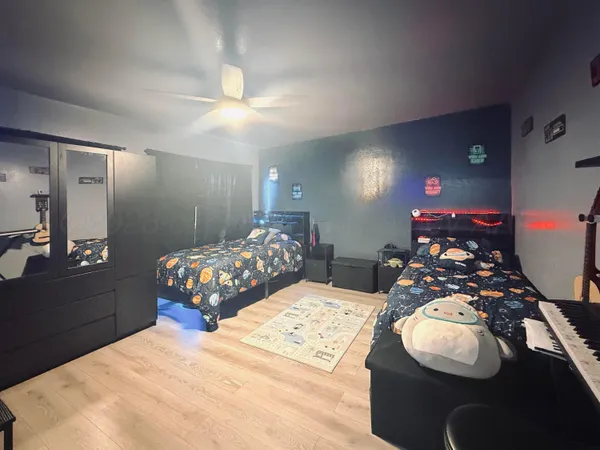 a bedroom with bed and a chandelier