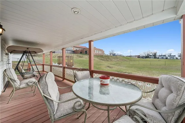 a view of a chair and table on the deck