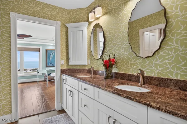 a bathroom with a double vanity sink and a mirror