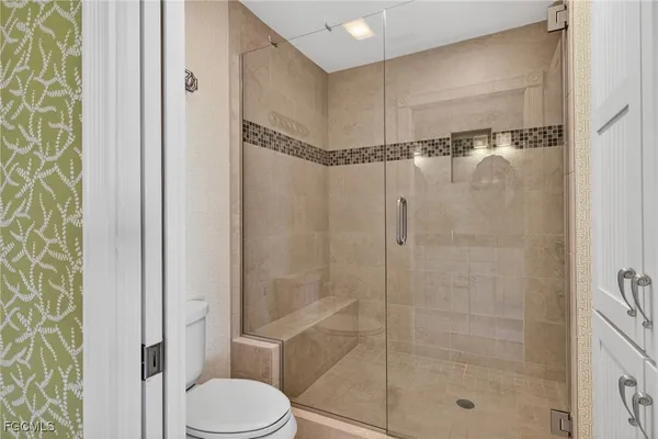a bathroom with a shower and a toilet