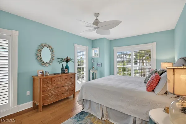 a bed room with a bed mirror and a window
