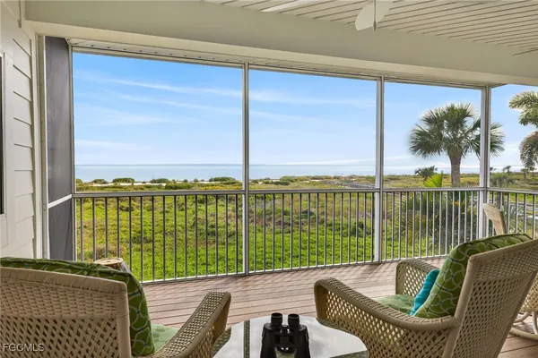 a view of a balcony with lake view and wooden floor
