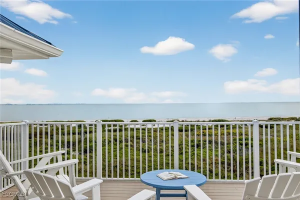 a view of a chair and table on the deck