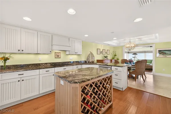 a kitchen with center island table and chairs