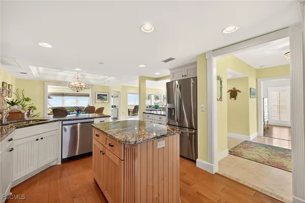 a kitchen with stainless steel appliances granite countertop a sink and a refrigerator